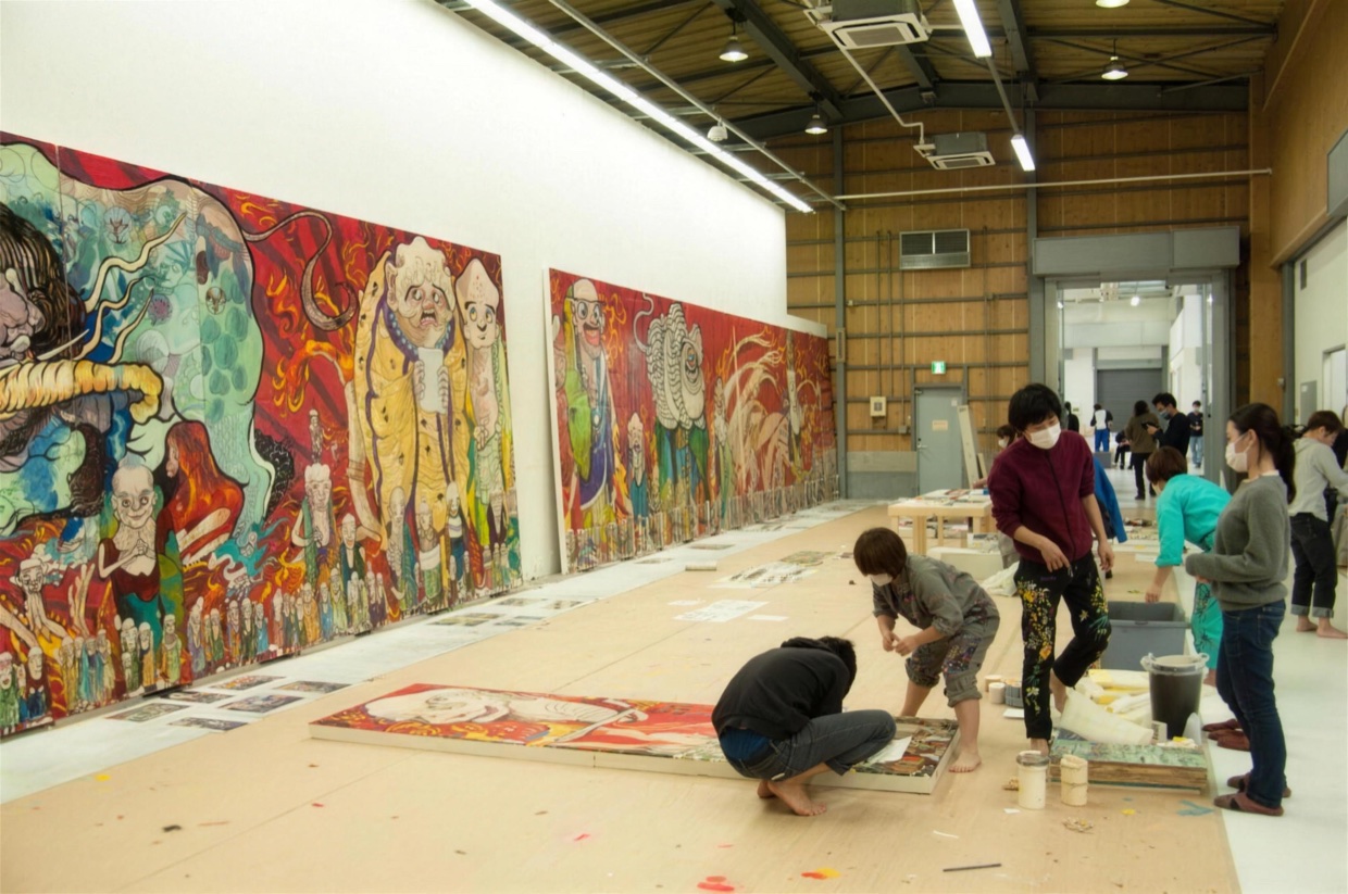 Production view of The 500 Arhats: teams of art students working side by side on sections of the enormous painting in the studio